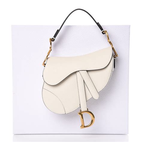 white and gold dior saddle bag
